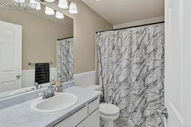 an empty room with white walls and cabinet