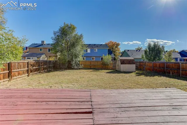a view of a dry yard with a house
