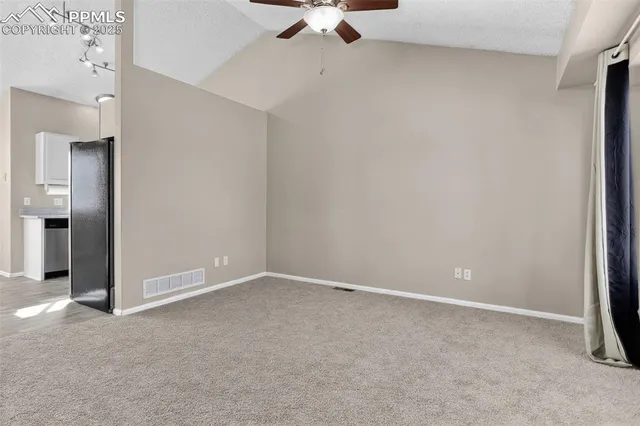 an empty room with window and glass door