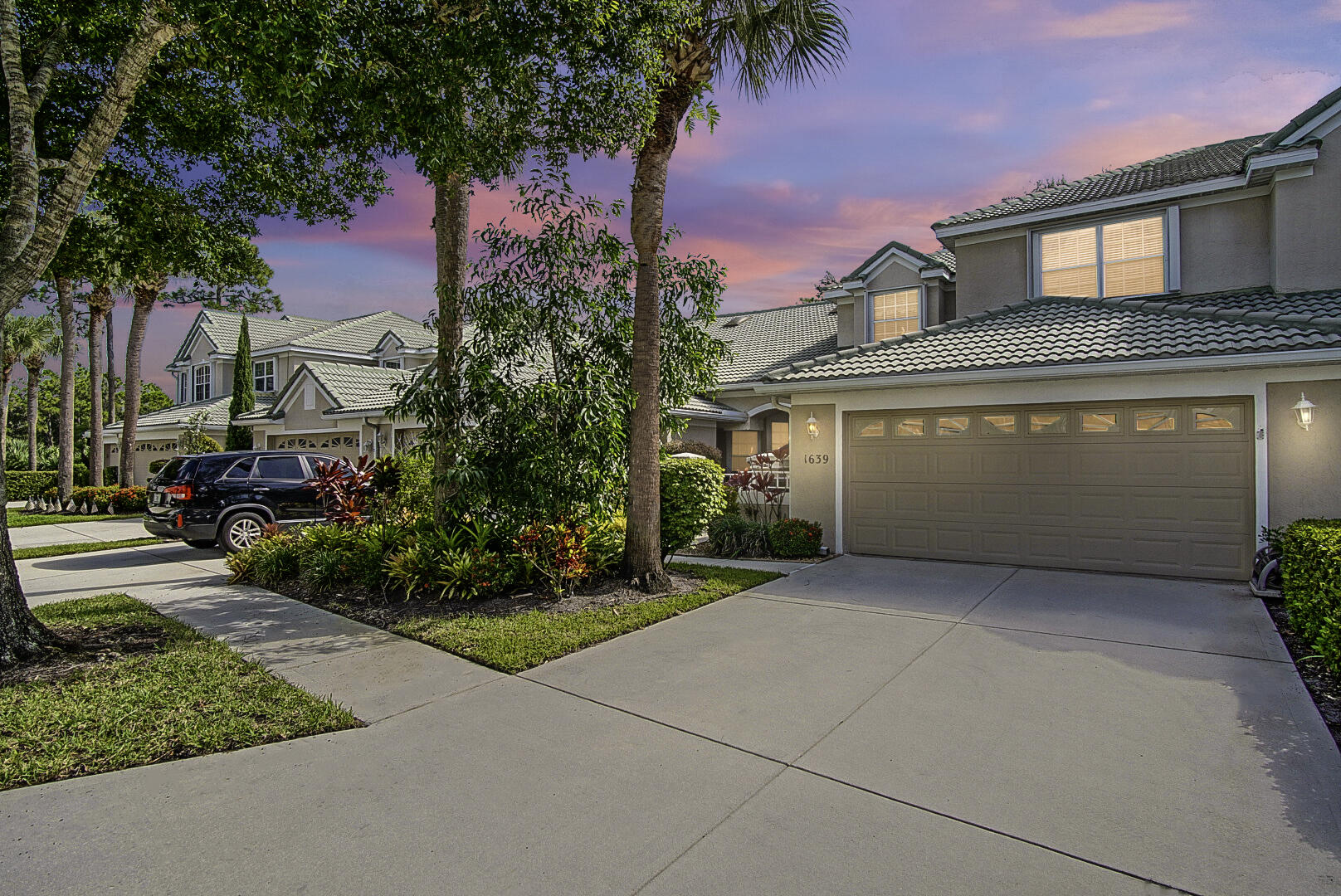 1639 Southwest Harbour Isles Circle, Unit 29 Port St. Lucie, FL 34986 - Photo 1 of 35 a front view of a house with a yard and garage