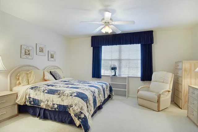 a spacious bedroom with a bed and window
