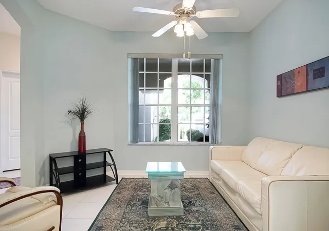 a living room with furniture and a chandelier