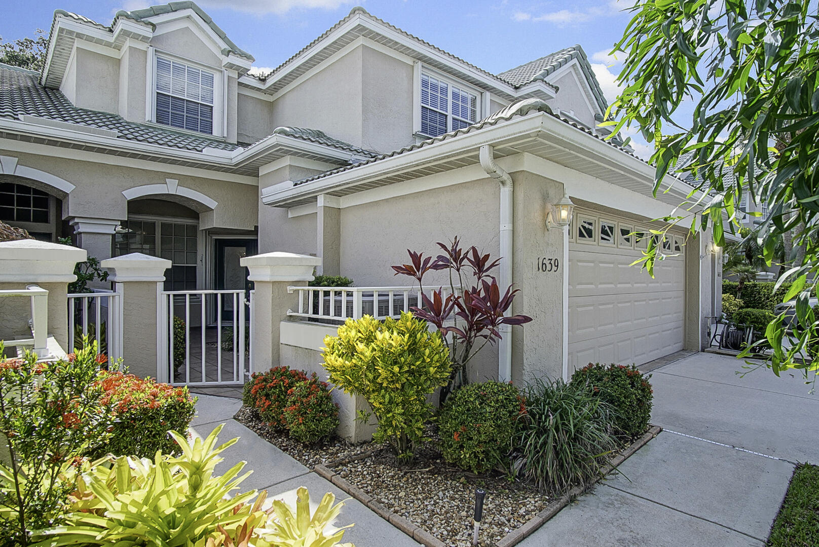 1639 Southwest Harbour Isles Circle, Unit 29 Port St. Lucie, FL 34986 - Photo 2 of 35 front view of a house with potted plants