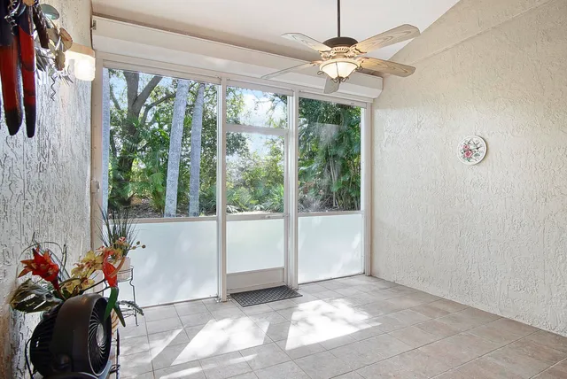 a view of a room with furniture and a large window