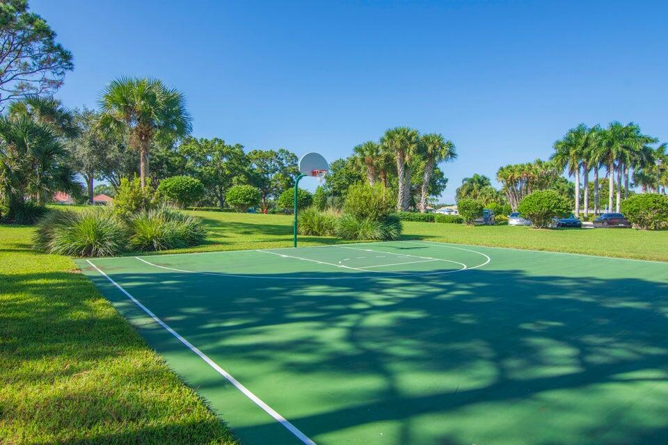 1639 Southwest Harbour Isles Circle, Unit 29 Port St. Lucie, FL 34986 - Photo 26 of 35 a backyard of a house with lots of green space and fountain