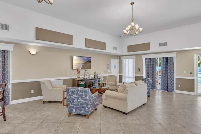 a living room with furniture and a chandelier
