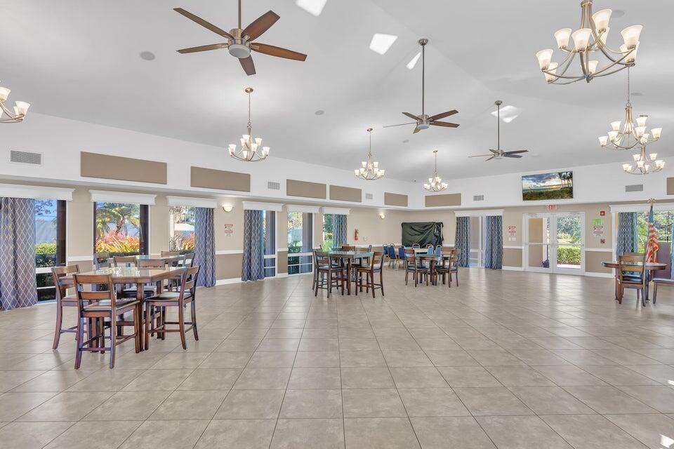 1639 Southwest Harbour Isles Circle, Unit 29 Port St. Lucie, FL 34986 - Photo 28 of 35 a view of a dining room with furniture window and wooden floor