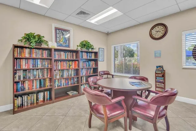 a dining room with furniture and a book shelf