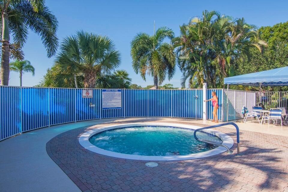 1639 Southwest Harbour Isles Circle, Unit 29 Port St. Lucie, FL 34986 - Photo 33 of 35 a swimming pool with wooden fence
