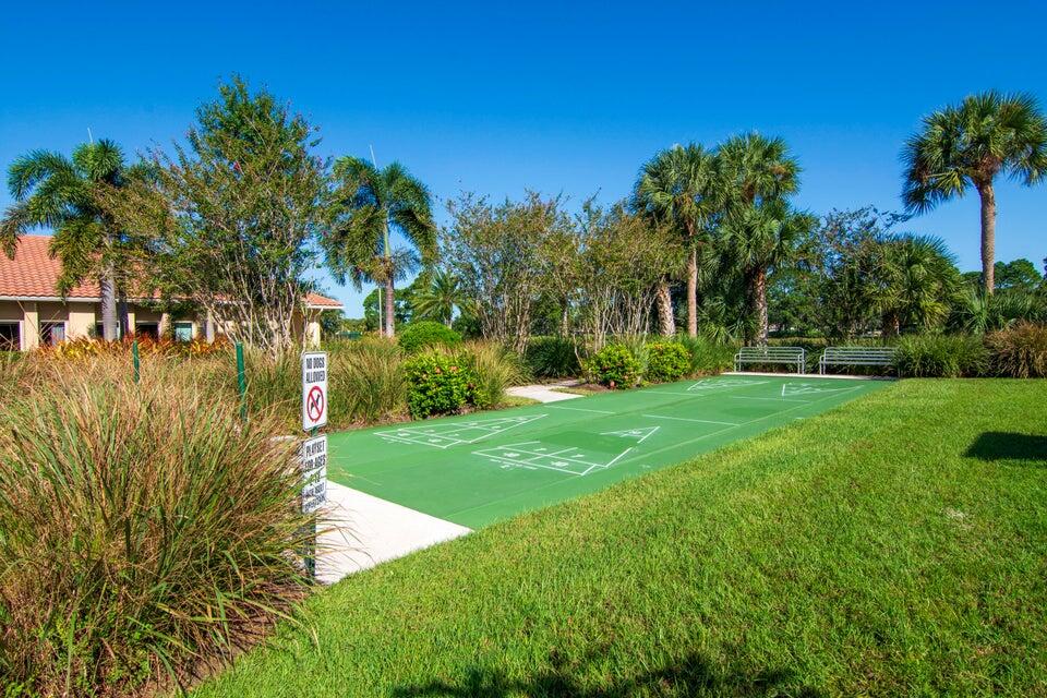 1639 Southwest Harbour Isles Circle, Unit 29 Port St. Lucie, FL 34986 - Photo 34 of 35 a view of a lake with a big yard