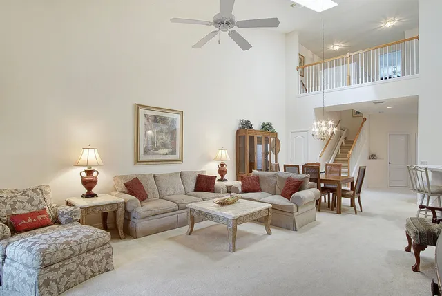 a living room with furniture and a chandelier