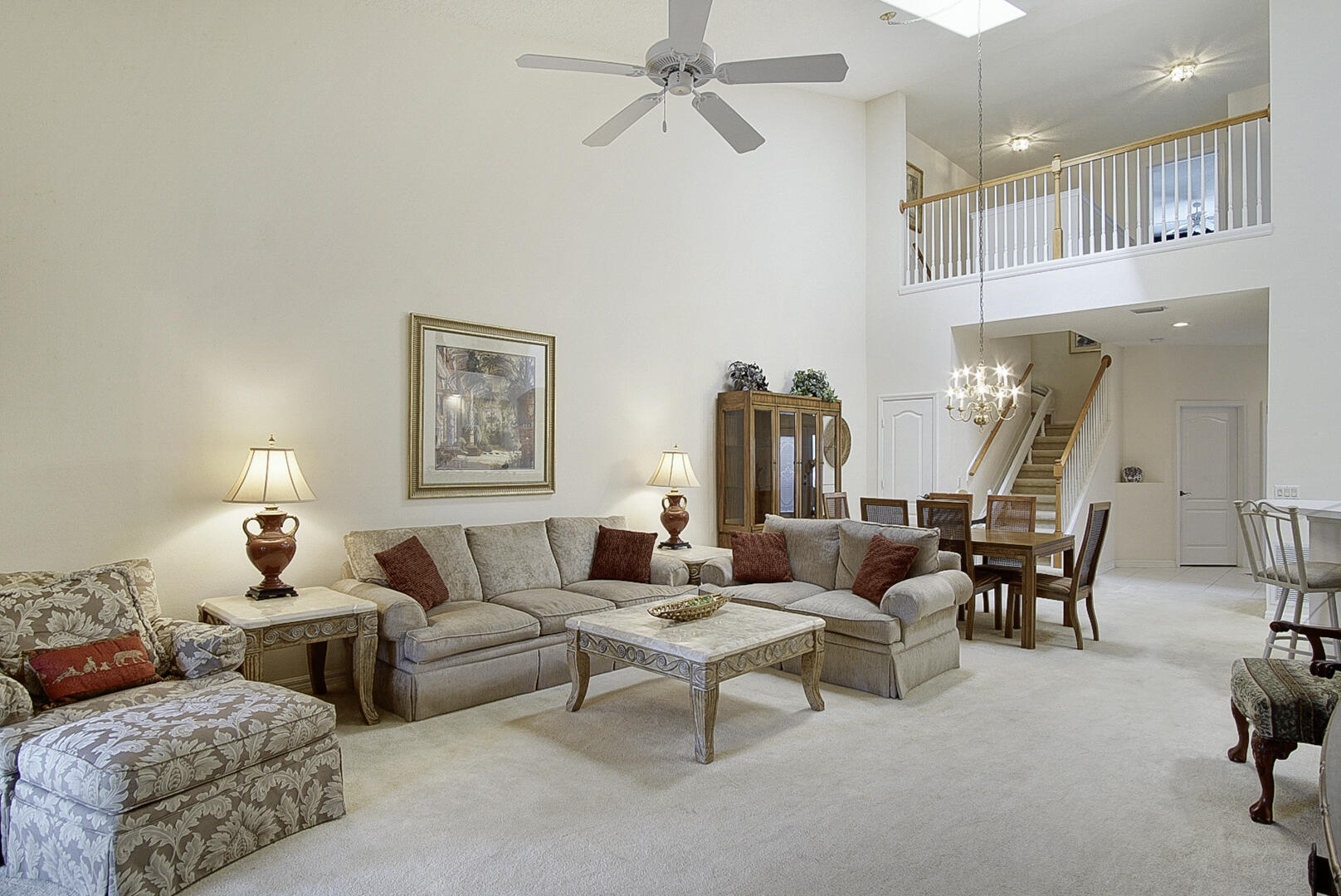 1639 Southwest Harbour Isles Circle, Unit 29 Port St. Lucie, FL 34986 - Photo 4 of 35 a living room with furniture and a chandelier