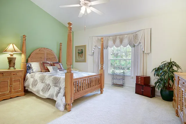 a bed sitting in a room next to a window