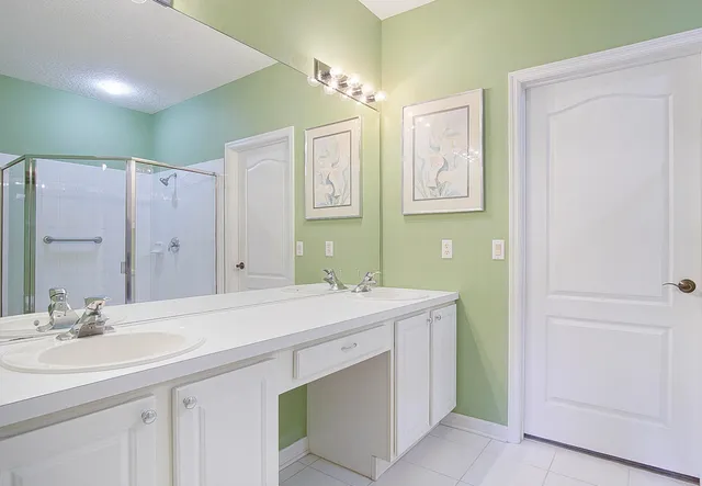 a bathroom with a sink double vanity and a mirror