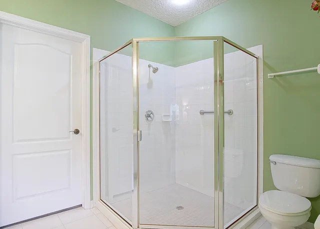 a bathroom that has a glass shower door