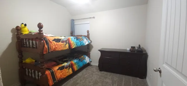 a bedroom with bed and a window