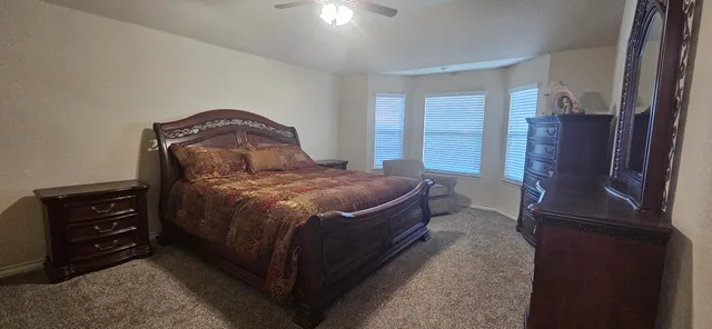 a bed sitting in a room next to a window