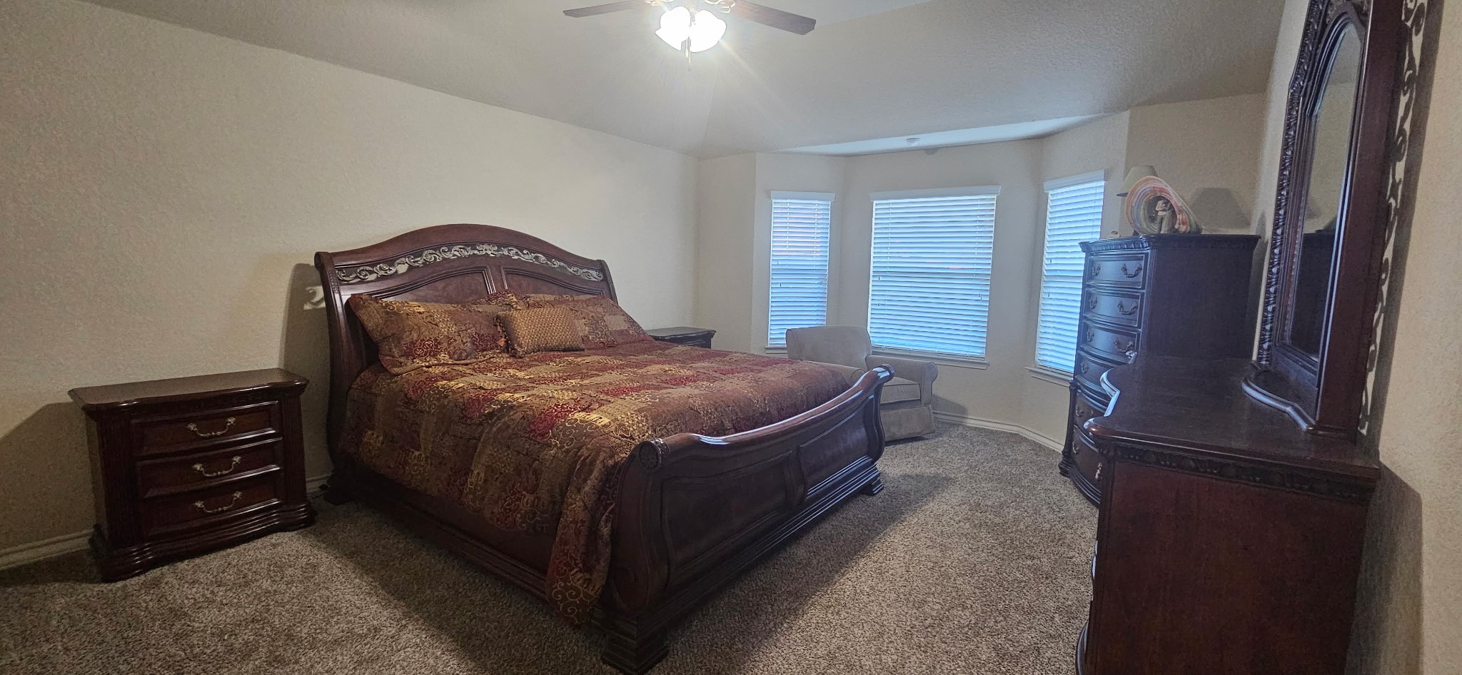 449 Cactus Flower Cibolo, TX 78108 - Photo 7 of 19 This spacious bedroom with a sitting area by a bay window, allowing natural light to fill the space.