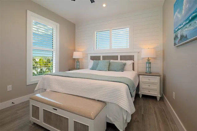 a bedroom with a bed and a ceiling fan