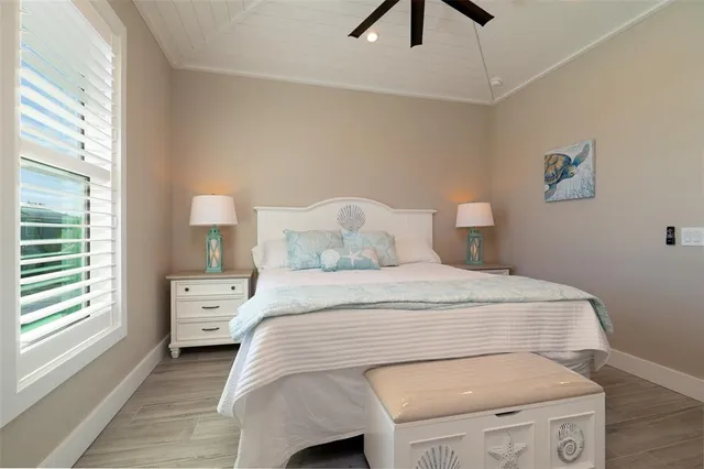 a bedroom with a bed and a night stand