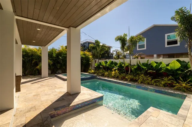 an aerial view of a house with swimming pool and porch