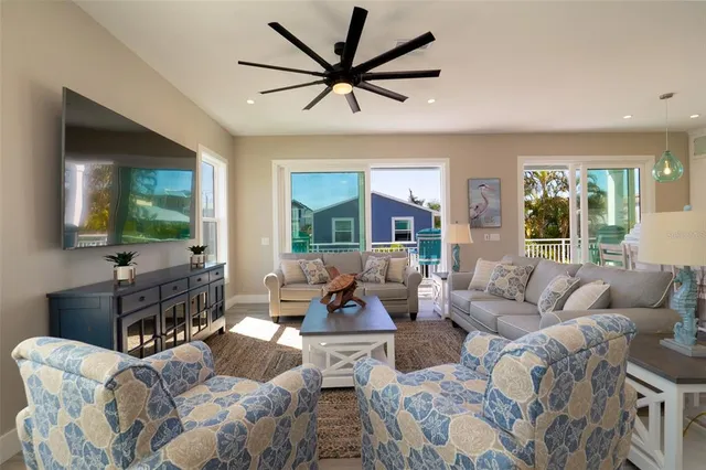 a large white kitchen with a large window and stove
