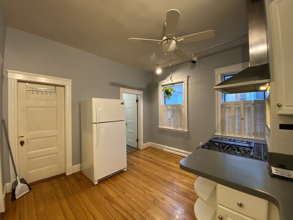 123 Cushing Avenue, Unit 1 Boston, MA 02125 - Photo 14 of 16 a living room with hard wood floors and a ceiling fan