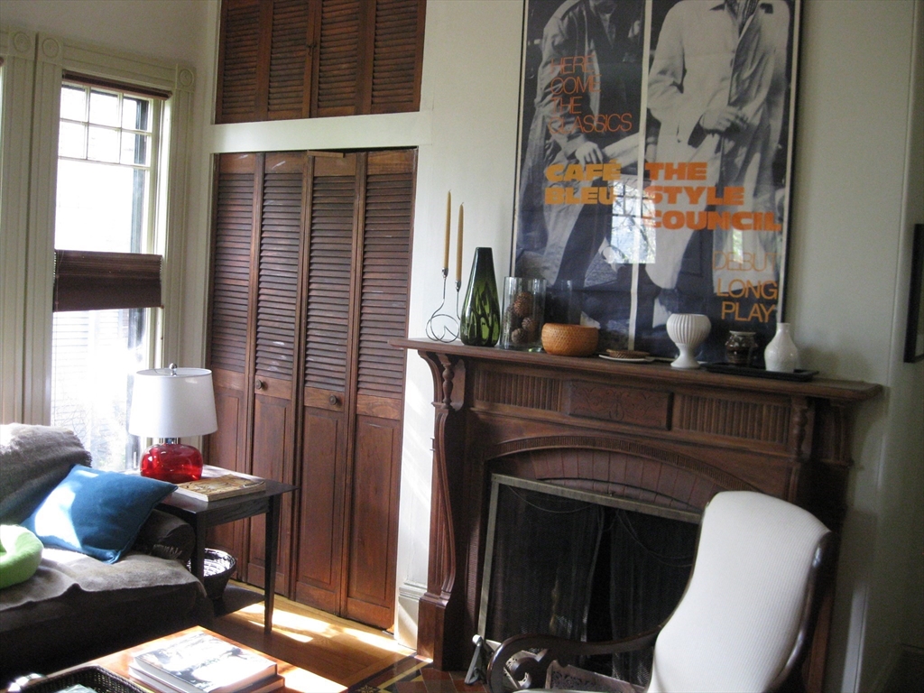 123 Cushing Avenue, Unit 1 Boston, MA 02125 - Photo 3 of 16 a living room with furniture and a fireplace