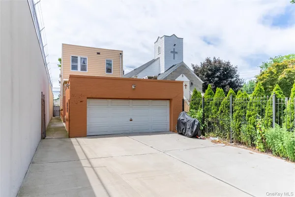 a view of a house with a yard and potted plants