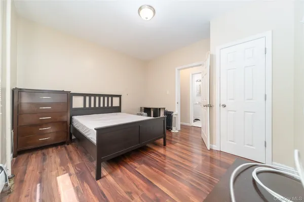 a bedroom with a bed and a dresser