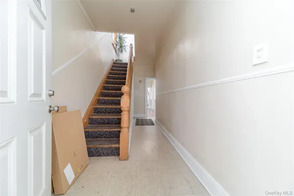 a view of entryway and hall with wooden floor