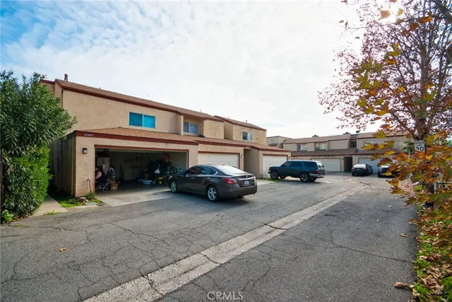 an empty room with wooden floor fireplace and windows