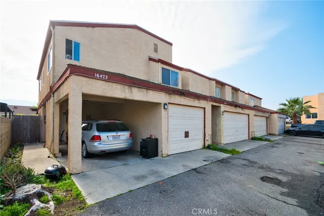 a kitchen with stainless steel appliances granite countertop a sink stove and white cabinets with wooden floor