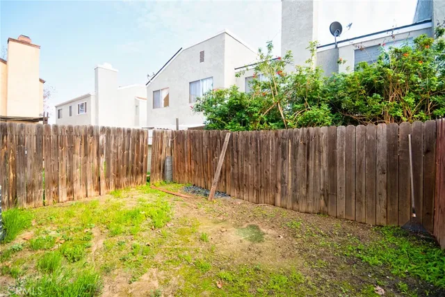 a view of empty room with wooden floor and window
