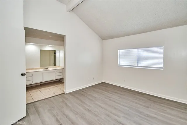 a view of a room with wooden floor and a window