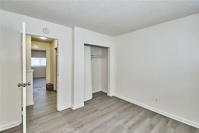 a view of a room with wooden floor and cabinet