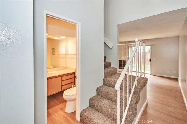 a bathroom with a sink a toilet and mirror