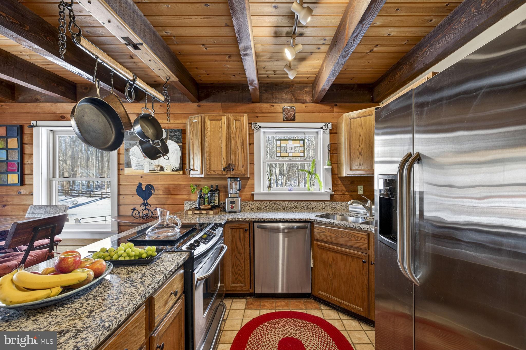 10418 Cliff Mills Road Marshall, VA 20115 - Photo 32 of 93 a kitchen with stainless steel appliances granite countertop a sink a stove and a wooden floor