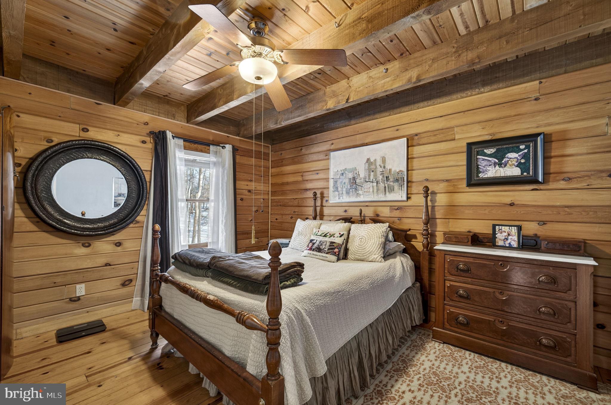 10418 Cliff Mills Road Marshall, VA 20115 - Photo 37 of 93 a bedroom with a bed and a chandelier