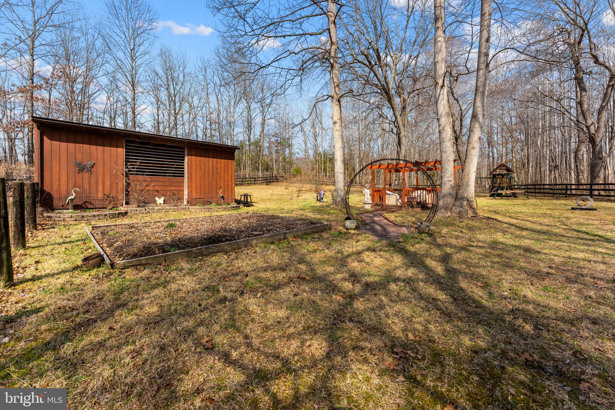 10418 Cliff Mills Road Marshall, VA 20115 - Photo 79 of 93 a backyard of a house with barbeque oven and outdoor seating