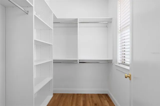 a view of walk in closet with empty racks