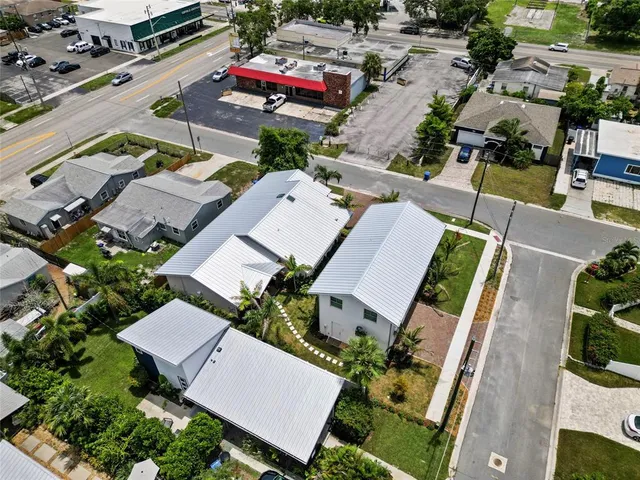 an aerial view of residential houses with outdoor space