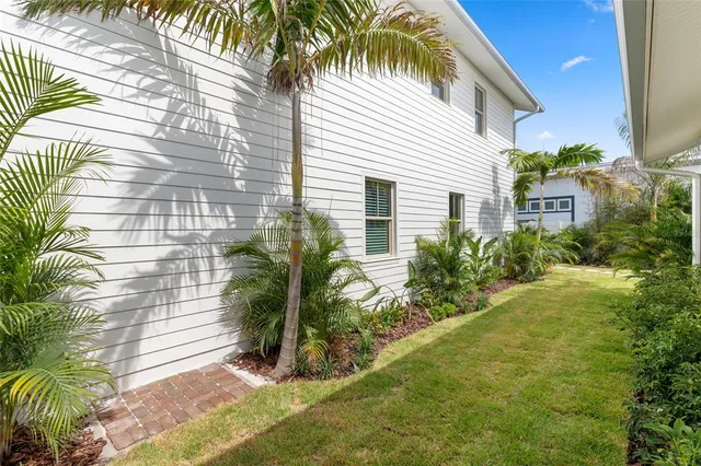 a view of a house with a yard and potted plants