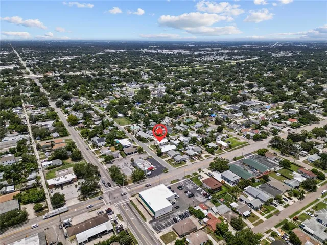 an aerial view of residential houses with city view