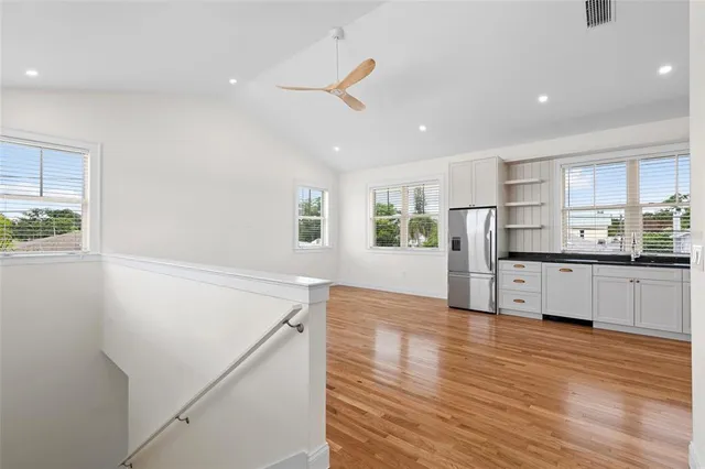 a view of kitchen with wooden floor and electronic appliances