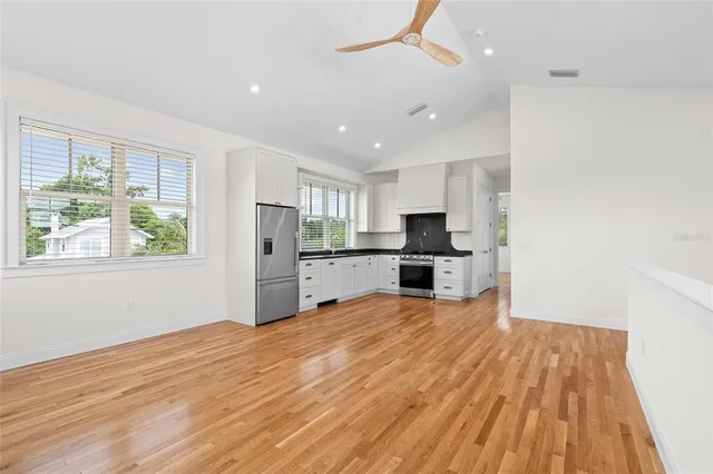 a view of kitchen with wooden floor and electronic appliances
