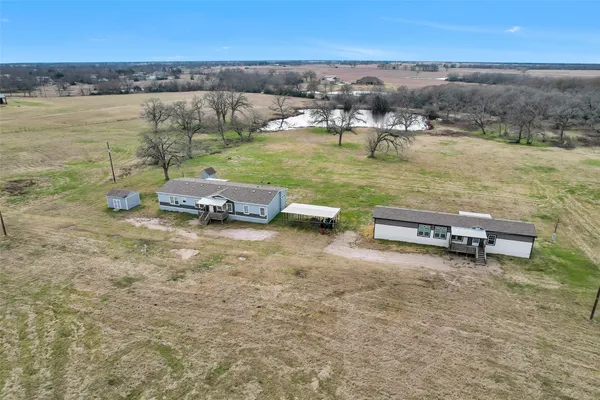 a view of a lake with lawn chairs