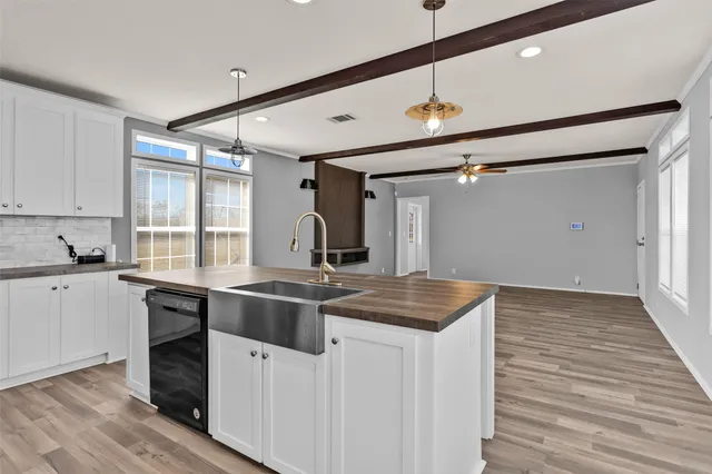 a kitchen with a sink stove and cabinets