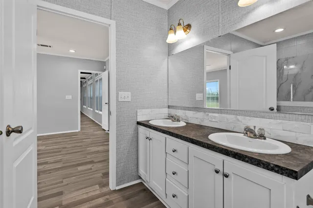 a bathroom with a sink double vanity and a mirror