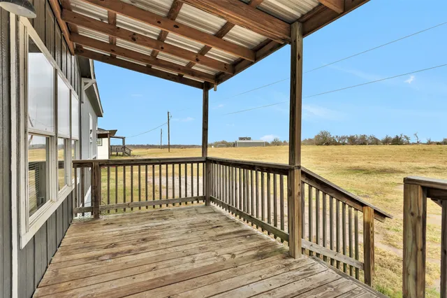 a view of a balcony with wooden floor